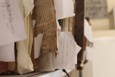 Genizah fragments sticking out on a shelf | Photo Credit: Maia Erickson 