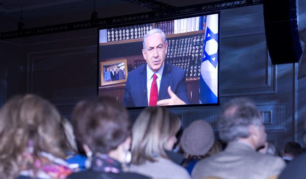 Participants at the 2014 Jewish Federations of North America General Assembly listen as Prime Minister Benjamin Netanyahu addresses the gathering via satellite at National Harbor, Maryland on Monday, November 10, 2014. Credit: Ron Sachs