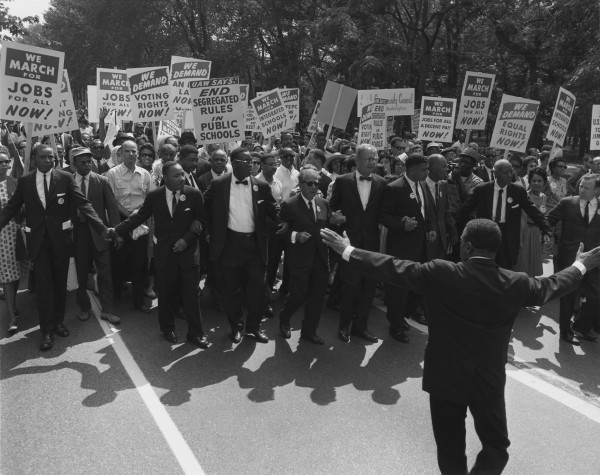 Jewish civil rights activist Joseph L. Rauh, Jr. marches with Martin Luther King in the 1963 March on Washington. | By United States Information Agency, Licensed under Public Domain via Commons.