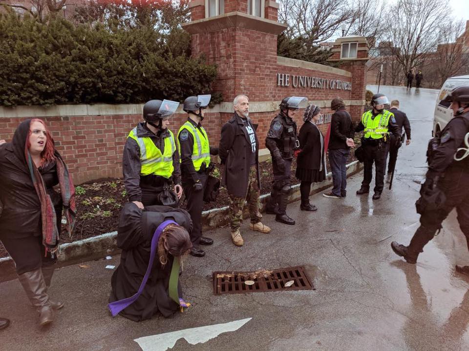 Campus police detain Eva Watler and other Mercy Junction protesters at the University of Tennessee at Knoxville on Feb. 17. | Photo courtesy of Mercy Junction