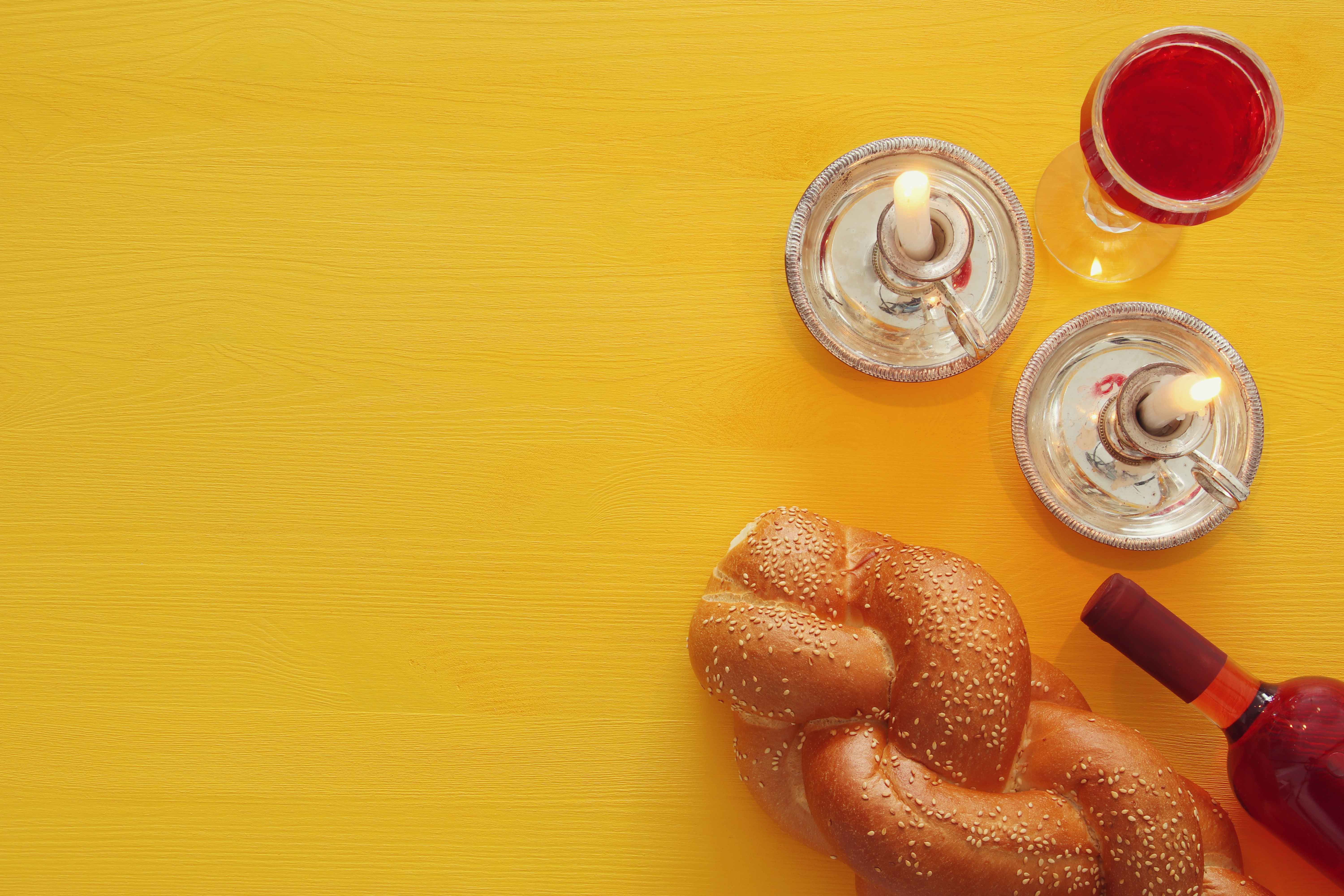shabbat image. challah bread, wine and candles. Top view.