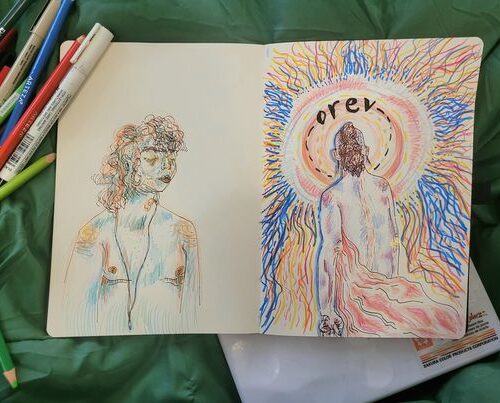 A sketchbook laid out on a green background with two images of a transmasculine individual, one looking to the right and colored with blue and orange, the other facing away, toward a circle of light that emanates in blue and orange around the paper.
