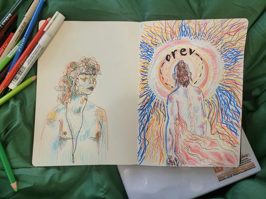 A sketchbook laid out on a green background with two images of a transmasculine individual, one looking to the right and colored with blue and orange, the other facing away, toward a circle of light that emanates in blue and orange around the paper.